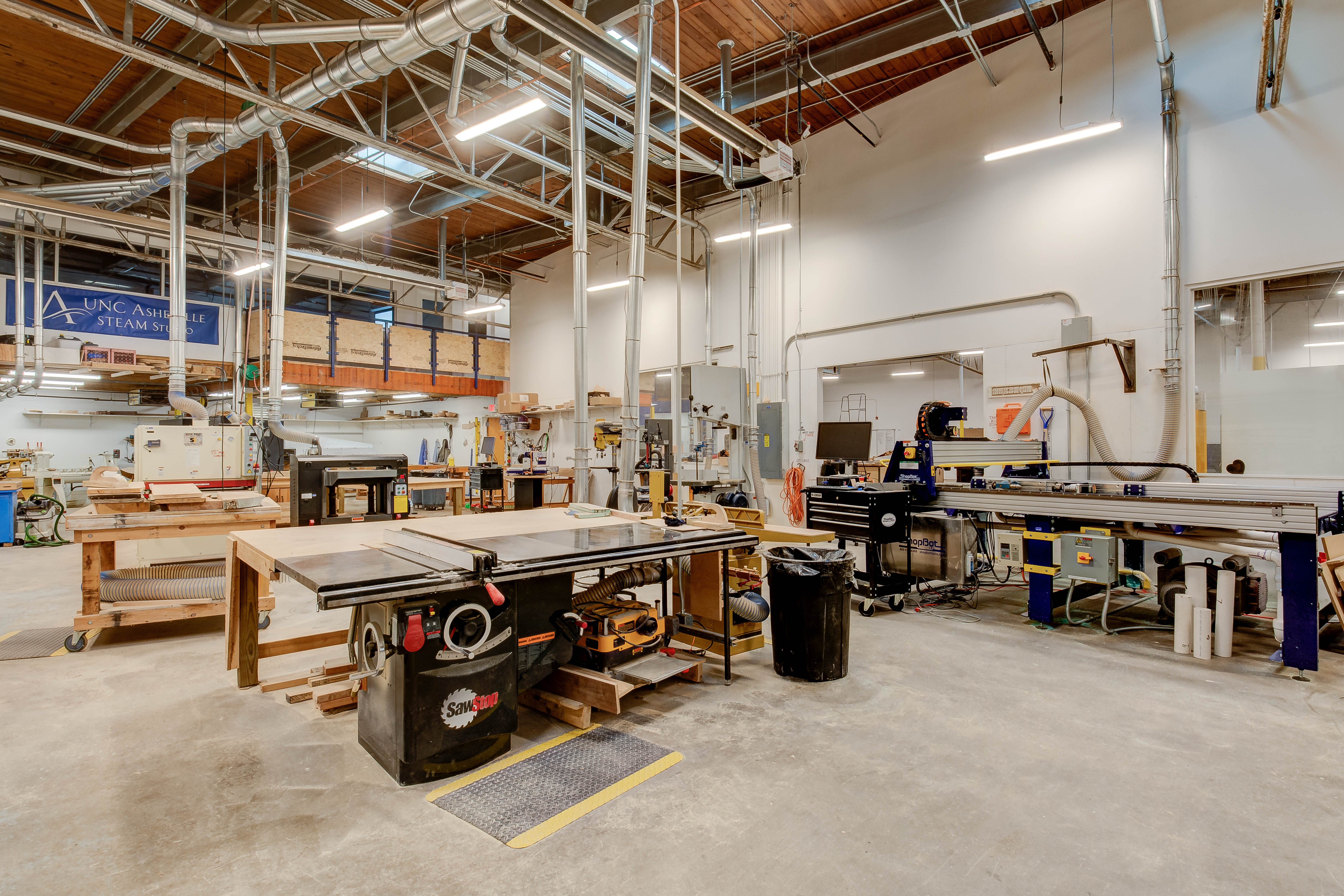 Photo showing the STEAM Studio woodshop; table saw and cnc router.