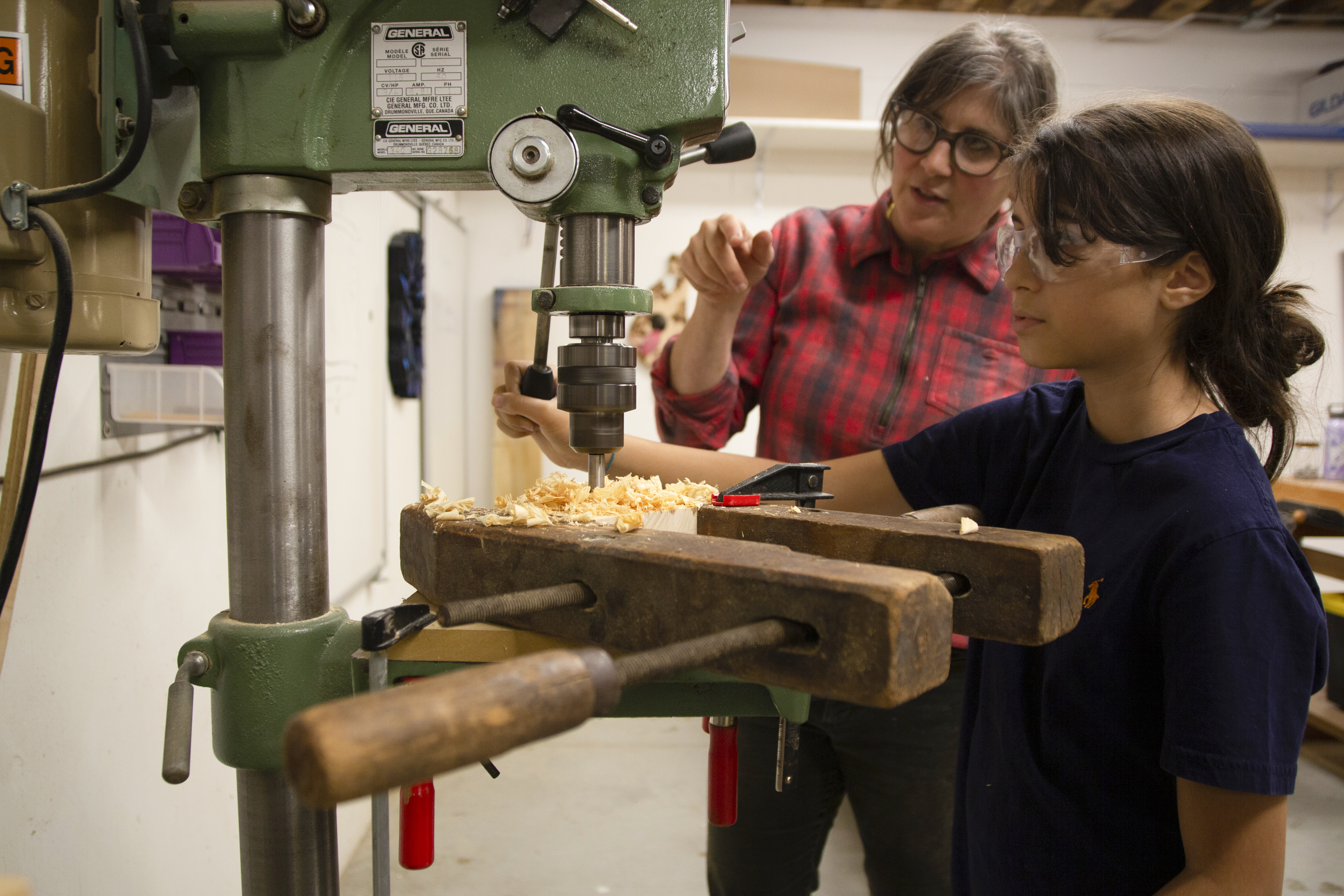 SkillSet Woodshop Instructor teaches student how to use the drill press
